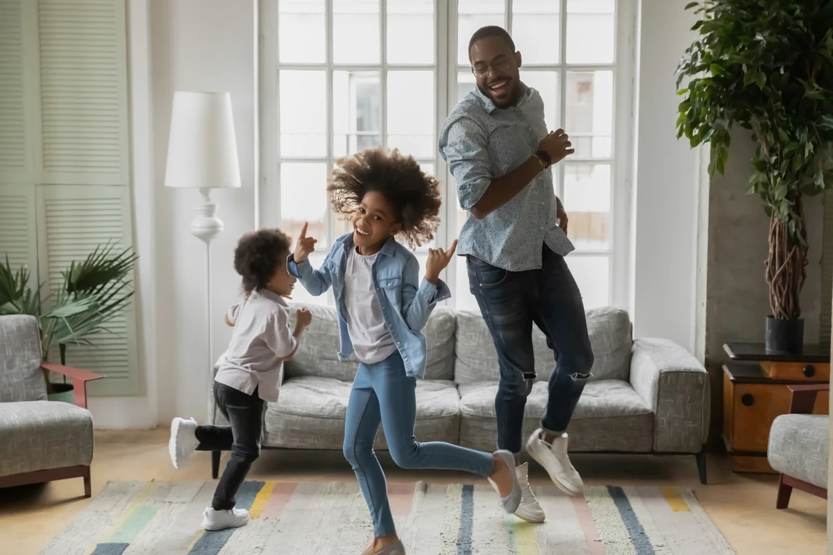 Mother and father playing with their kid in their Smart home 