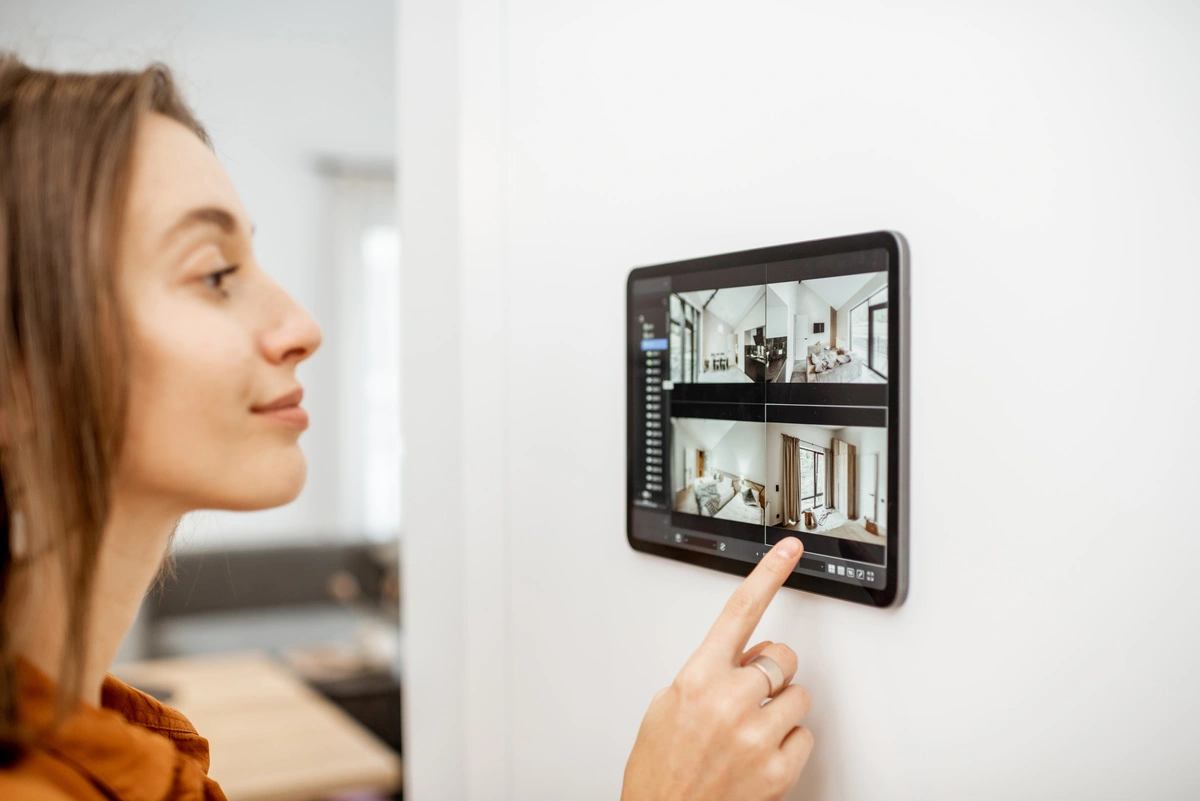 A woman watching her smart home system from the tablet 