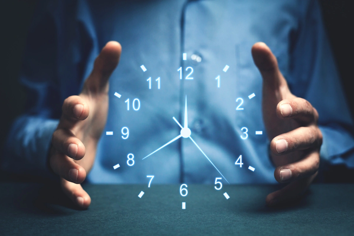 A clock between two hands